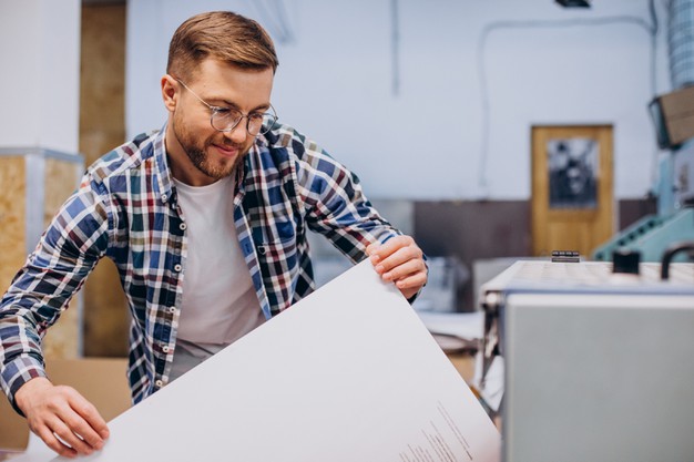 Man trying to paper in the printing machine
